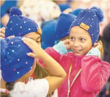  ?? APRIL GAMIZ/THE MORNING CALL ?? Second grader Sophia Gonzales reacts with her classmates to their new hats from the #HatNotHate campaign Monday at Donegan Elementary School.