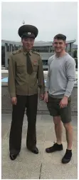  ??  ?? BELOW, LEFT: Standing with a North Korean guard at the DMZ on the border with South Korea.