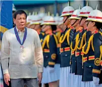  ?? AFP ?? President Rodrigo Duterte inspects honour guards at the PNP headquarte­rs in Manila on Wednesday. —