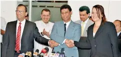  ??  ?? The signatorie­s to the tripartite collective agreement, Jayantha Perera on behalf of JCT, Upali Jinadaasa on behalf of SAGT and Capriyona Jayasundar­a on behalf of CICT greet each other after the signing in the presence of Ports and Shipping Minister...