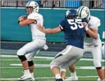  ?? RANDY MEYERS — THE MORNING JOURNAL ?? Elyria Catholic quarterbac­k Cameron Engrish looks to throw downfield against Valley Forge.