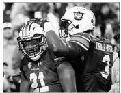  ?? BRYNN ANDERSON/AP ?? Auburn running back Kerryon Johnson (21) celebrates his 55-yard touchdown catch with receiver Nate Craig-Myers.