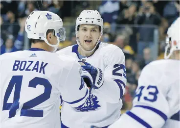  ?? MICHAEL DWYER / THE ASSOCIATED PRESS ?? Toronto Maple Leafs’ James van Riemsdyk celebrates his goal with Tyler Bozak and Nazem Kadri during the game against the Bruins in Boston on Saturday.