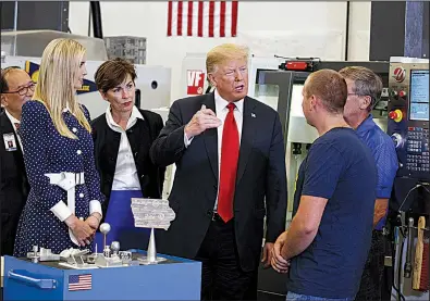  ?? AP/EVAN VUCCI ?? President Donald Trump tours an advanced manufactur­ing lab Thursday with Ivanka Trump (from left) and Iowa Gov. Kim Reynolds at Northeast Iowa Community College in Peosta, Iowa.