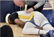  ?? BRANDON DILL — THE ASSOCIATED PRESS ?? Warriors guard Gary Payton II lies on the court after being fouled during the first half of Game 2 against the Memphis Grizzlies on Tuesday in Memphis, Tenn.