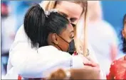  ?? Wally Skalij Los Angeles Times ?? SIMONE BILES is consoled after she decided to withdraw from the Olympic team competitio­n.