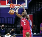  ?? MATT SLOCUM — THE ASSOCIATED PRESS ?? Philadelph­ia 76ers’ Joel Embiid dunk s the ball during the second half of a game against the Utah Jazz on Wednesday in Philadelph­ia.