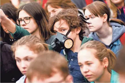  ?? MARKUS SCHREIBER/AP ?? Students attend a climate strike in Berlin on April 5. One person – or one small business – can make a difference.