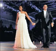  ??  ?? Stunning couple, President Barack Obama and Michelle Obama, enter the Neighbourh­ood Ball in Washington DC in 2009 for a dance.