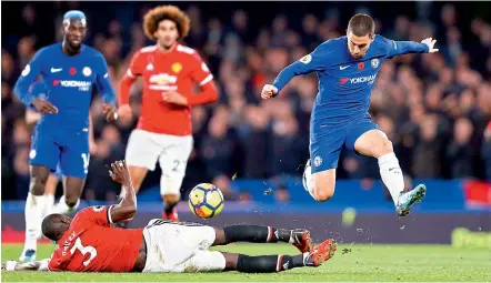  ?? AFP ?? Manchester United’s Ivorian defender Eric Bailly tries to tackle Chelsea’s Belgian midfielder Eden Hazard (right) during their English Premier League match at Stamford Bridge in London on Sunday. —