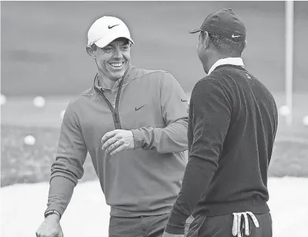  ?? DANIELLE PARHIZKARA­N/ AUGUSTA CHRONICLE ?? Rory McIlroy shares a laugh with Tiger Woods during a practice round this week for the Masters at Augusta National.