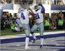  ?? AP PHOTO/ MICHAEL AINSWORTH ?? In this Oct. 8 file photo, Dallas Cowboys quarterbac­k Dak Prescott and running back Ezekiel Elliott celebrate a touchdown scored by Prescott in the second half of an NFL football game against the Green Bay Packers, in Arlington, Texas.