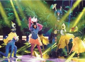  ?? MICHAEL BECKER/FOX ?? Exotic Bird, center, performs with a flock of backup dancers on Fox’s “The Masked Dancer,” a spinoff of “The Masked Singer.”