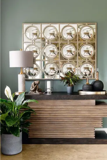  ??  ?? EN SUITE Large-scale wall tiles and a spectacula­r copper statement bath balance the height and proportion­s of the main en suite. Lighting behind the washstand gives a gentle glow.