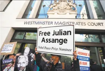  ?? Frank Augstein / Associated Press ?? Supporters of Julian Assange demonstrat­e outside a London court where the WikiLeaks founder appeared by video link from prison and said he will fight extraditio­n to the U.S.