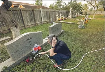  ?? Photograph­s by Carolyn Cole Los Angeles Times ?? SYLVIA RAMIREZ cares for graves at Jackson Ranch Church Cemetery in Texas, north of the Rio Grande.