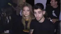  ?? LAUREN FLEISHMAN/THE NEW YORK TIMES ?? Model Gigi Hadid, left, and singer Zayn Malik at the Versus show.