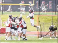  ?? H John Voorhees III / Hearst Connecticu­t Media ?? New Fairfield players celebrate the final goal of the game which put New Fairfield up 13-11 to defeat Hand in the Class M championsh­ip Saturday in Norwalk.