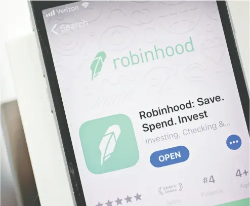  ?? ANDREW HARRER / BLOOMBERG ?? The code in the Robinhood app doesn’t indicate where the spare change will come from, but other apps typically connect to a debit or credit card. They round up purchases to the nearest dollar and automatica­lly invest that difference.