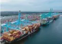  ?? STEVE HELBER/AP ?? The Mediterran­ean Shipping Company ship MSC Meline, front, is in the process of being loaded at the Virginia Internatio­nal Gateway Marine terminal Dec. 1 in Norfolk.