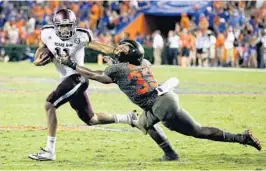  ?? JOHN RAOUX/AP ?? Texas A&M quarterbac­k Kellen Mond, left, scrambles to get away from Florida linebacker David Reese during their October game. Reese leads the Gators with 71 tackles.