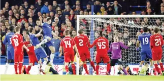  ??  ?? WINNING GOAL: Chelsea's Branislav Ivanovic, top, heads the ball and scores against Liverpool during the English League Cup semifinal second leg at Stamford Bridge stadium in London on Tuesday night. (AP)