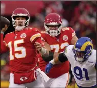  ?? (AP/Charlie Riedel) ?? Kansas City Chiefs quarterbac­k Patrick Mahomes passes as he is pressured by Los Angeles Rams defensive tackle Greg Gaines during the first half Sunday in Kansas City, Mo. Mahomes threw for 320 yards and a touchdown as the Chiefs won 26-10. More photos at arkansason­line.com/1128lakc/