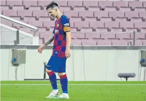  ?? AFP ?? A dejected Lionel Messi walks off the pitch after Barca drew with Atletico Madrid.