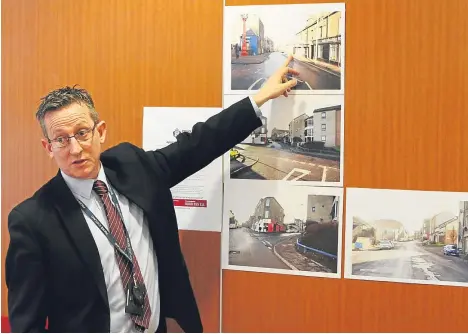  ??  ?? DCI Iain Wales with images of the Hilltown and Mains Road where John was found.