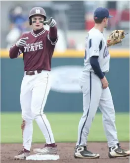  ?? (Photo by Trevor Birchett, MSU athletic communicat­ions, for Starkville Daily News) ?? Mississipp­i State’s Justin Foscue, left, points toward the dugout during Saturday’s first game against Ole Miss.