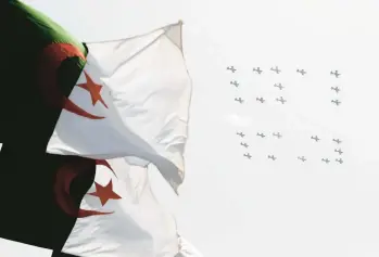  ?? TOUFIK DOUDOU/AP ?? Algerian celebratio­n: Planes fly in formation to display the number 60 during a military parade Tuesday in Algiers marking the 60th anniversar­y of Algeria’s independen­ce from France. During the African country’s first such parade in 38 years, the government pardoned 14,000 prisoners, but it was not clear if that number included political prisoners.