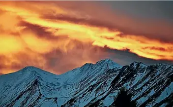  ?? GEORGE EMPSON ?? Red in the morning, shepherds’ warning . . . sunrise over the Two Thumb Range on Sunday morning.