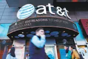  ?? Kena Betancur / AFP / Getty Images 2016 ?? AT&T will take over Time Warner, a move that is expected to unleash a wave of corporate mergers.