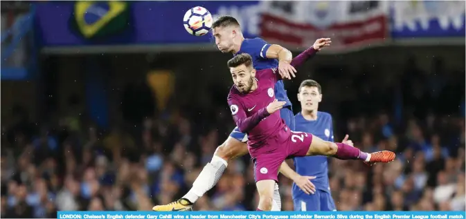  ?? — AFP ?? LONDON: Chelsea’s English defender Gary Cahill wins a header from Manchester City’s Portuguese midfielder Bernardo Silva during the English Premier League football match between Chelsea and Manchester City at Stamford Bridge in London yesterday.