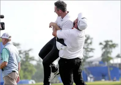  ?? AP photo ?? Shane Lowry hoists up teammate Rory McIlroy after they won the PGA Zurich Classic golf tournament at TPC Louisiana in Avondale, La.