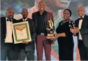  ?? Picture: LUVUYO MEHLWANA ?? JUMP FOR JOY: Luvo Manyonga accepts his Sports Star of the Year award at the Eastern Cape Sport and Recreation­al Achievers Awards. With him are, from left, EC Sports Confederat­ion president Mkhululi Magada, King Mpendulo Sigcawu, MEC Bulelwa Tunyiswa and Eastern Cape premier Phumulo Masualle.