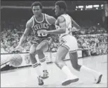  ?? FRED JEWELL, THE ASSOCIATED PRESS ?? Jo Jo White drives past Chicago Bulls’ Wilbur Holland on Dec. 30, 1977.