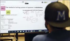  ?? The Maui News / MATTHEW THAYER photos ?? Maui High School math teacher Shawn Mongenyip sits in front of a large-screen monitor while remotely teaching students how to solve equations on Feb. 26. The technology that shaped education during the pandemic will likely have in impact in the classroom for years to come.