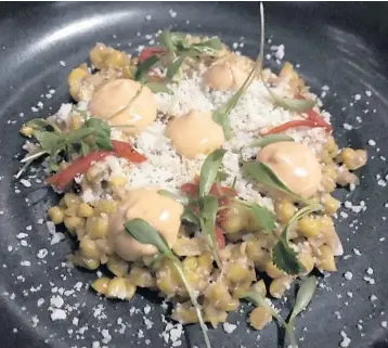  ?? MICHAEL MAYO/SUN SENTINEL ?? The Mexican roasted corn ($11) at One Door East is one of many fine vegetarian dishes from chef Joe Mizzoni, and a perfect accompanim­ent to chicken mole.