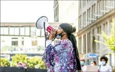  ?? Alexandra Wimley/ Post- Gazette ?? Activist Lorenzo Rulli leads protesters in chants during a
“Civil Saturdays” protest Satuday outside of Gateway Station, Downtown. Later in the day, Mr. Rulli was seen in a viral video confrontin­g patrons of Downtown restaurant­s.