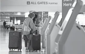  ?? TONY GUTIERREZ/AP ?? The number of people going through U.S. airports hit pandemic-era highs last weekend, and those records are almost certain to be broken over the Memorial Day holiday.