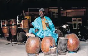  ?? Photo: Boureima HAMA/AFP ?? Drumming up support: Percussion­ist Oumarou Adamou is trying to preserve Nigerien traditiona­l music.