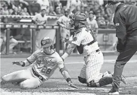  ?? AP ?? Omar Narvaez tags out Washington's Lane Thomas at home in the seventh inning Friday night. Thomas tried to stretch a triple into an inside the park home run.