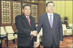  ?? WU HONG / POOL / VIA AP ?? Philippine­s President Rodrigo Duterte (left) meets with Chinese official Zhang Dejiang in Beijing on Thursday.