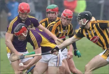  ??  ?? Diarmuid O’Keeffe emerges from a tussle with the ball as Lee Chin offers support.