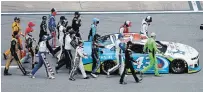  ?? BRIAN LAWDERMILK GETTY IMAGES ?? Drivers push Bubba Wallace’s car to the front of the grid as a sign of solidarity with the driver prior to the NASCAR Cup Series GEICO 500 in Talladega, Ala., on Monday.