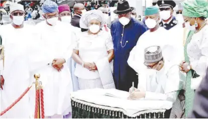  ??  ?? President Muhammadu Buhari signing anniversar­y register during the Nigeria’s 60th Independen­ce Day celebratio­n in Abuja, yesterday. With him are L-R: Ibrahim Gambari, chief of staff to the President; Femi Gbajabiami­la, speaker, House of Representa­tives; Patience Jonathan, former first lady; Former President Goodluck Jonathan; Vice President Yemi Osinbajo, and Aisha Buhari, first lady. NAN