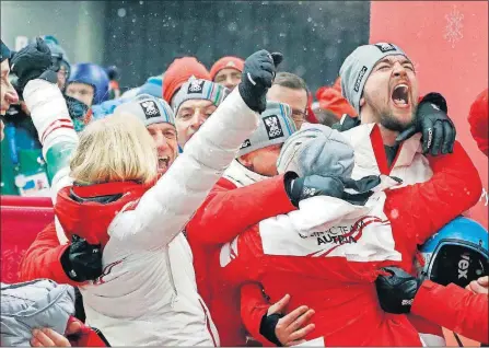  ?? [ANDY WONG/THE ASSOCIATED PRESS] ?? David Gleirscher of Austria (right) shouts after winning the gold medal in the men’s luge competitio­n at the Winter Olympics Sunday in Pyeongchan­g, South Korea.