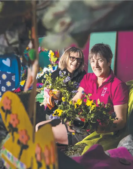  ?? Picture: Kevin Farmer ?? READY TO FLY: Putting the finishing touches on their float at Life Without Barriers staff Deb Dell (left) and Nerrida Wolfe. The Grand Central Floral Parade starts at 10am today and is butterfly-themed.