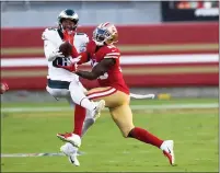  ?? RANDY VAZQUEZ — BAY AREA NEWS GROUP, 2020 ?? The 49ers’ Jaquiski Tartt, right, nearly intercepts a ball intended for the Eagles’ Richard Rodgers during the first quarter at Levi’s Stadium on Oct. 4.